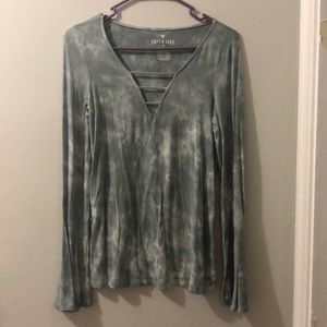 Long sleeve shirt with flowy cuffs .